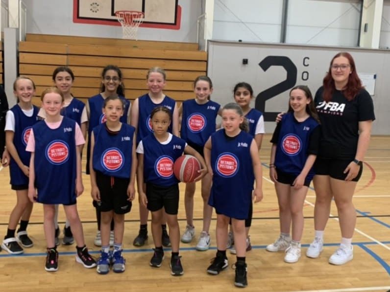 Image of a junior basketball team with their coach.