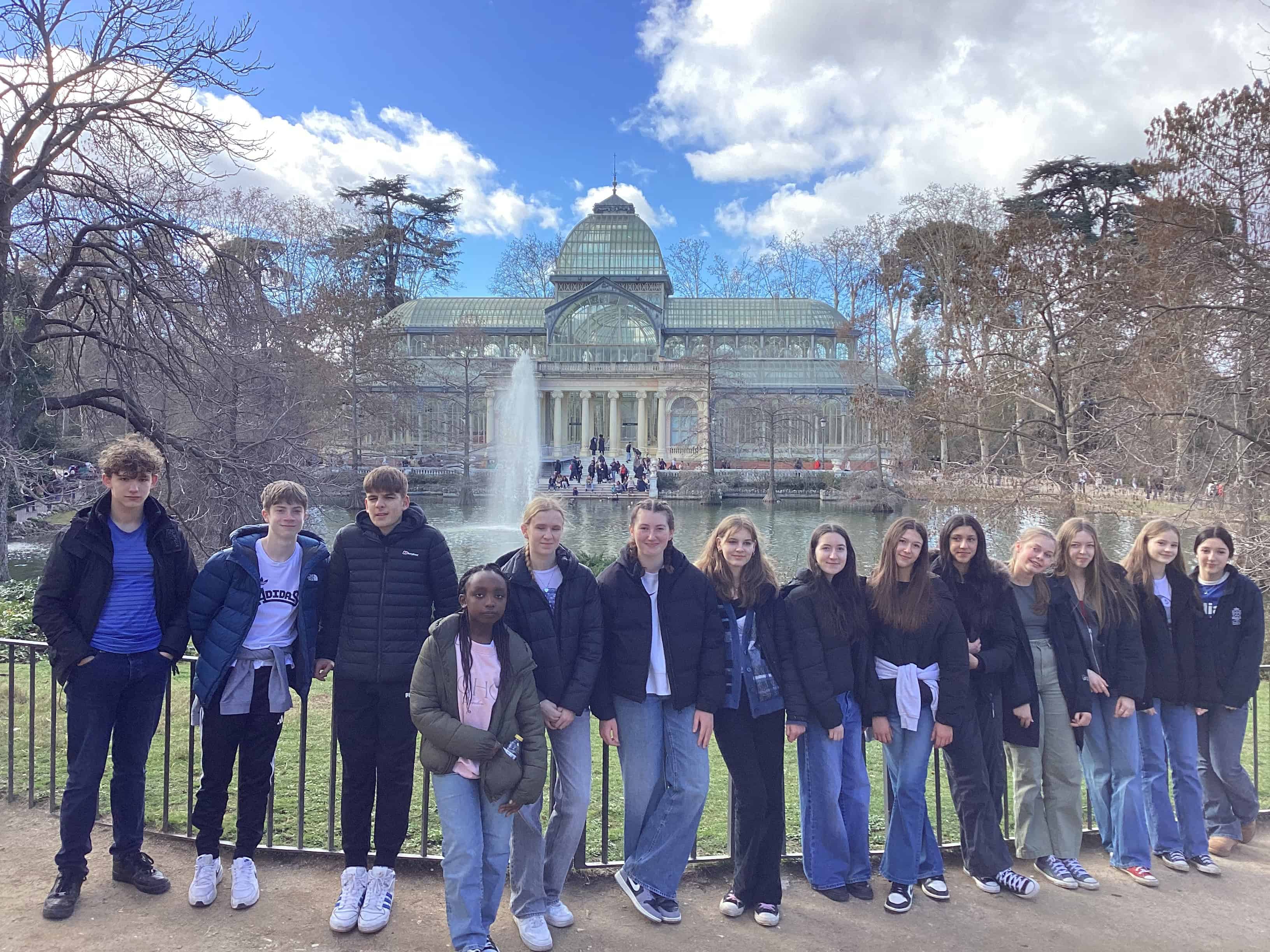 Students from Priestnall School stand in front of a Lake at El Retiro Park.