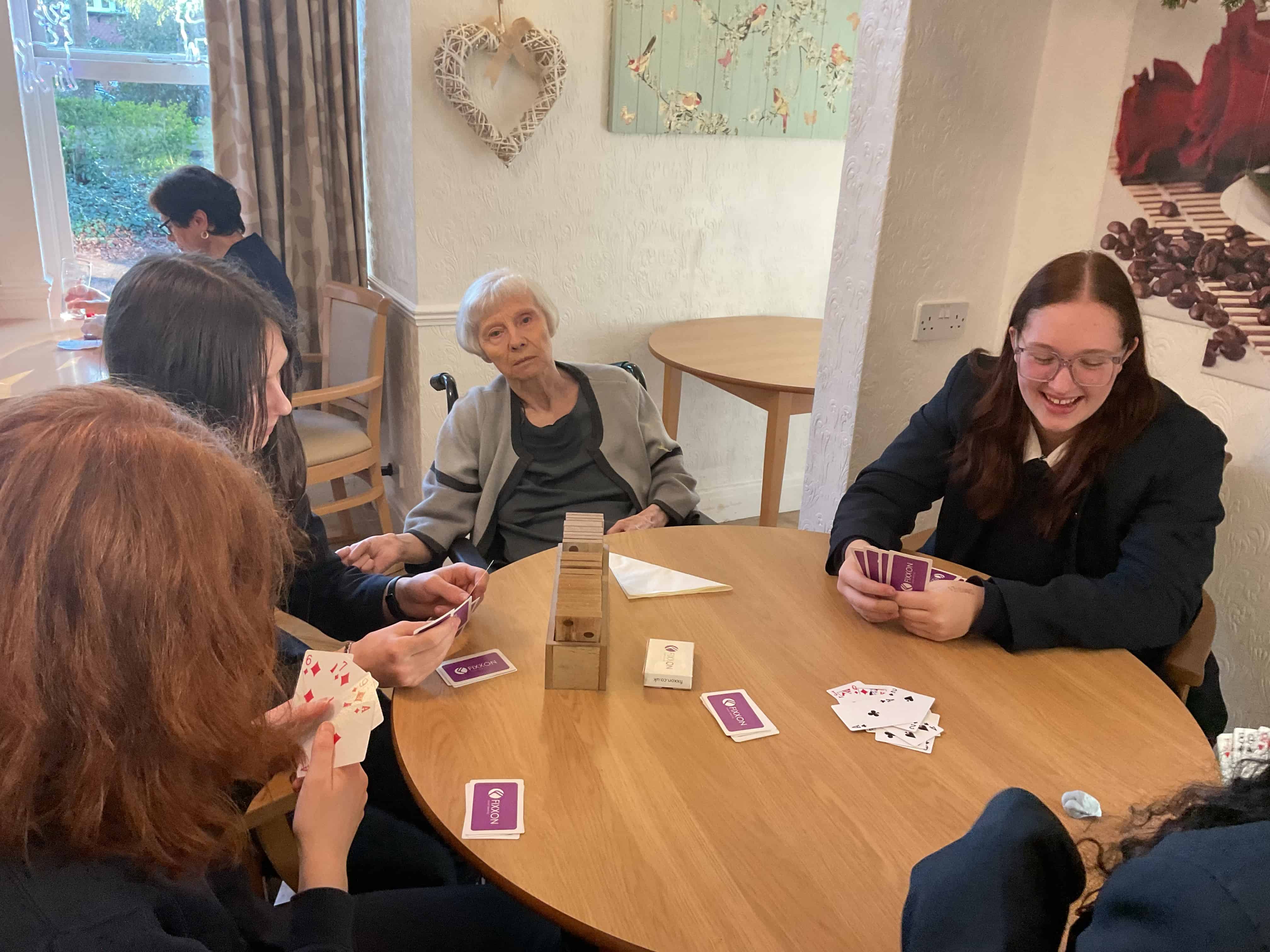 Students from Priestnall School play cards with residents at Priestnall Court Residential Home.