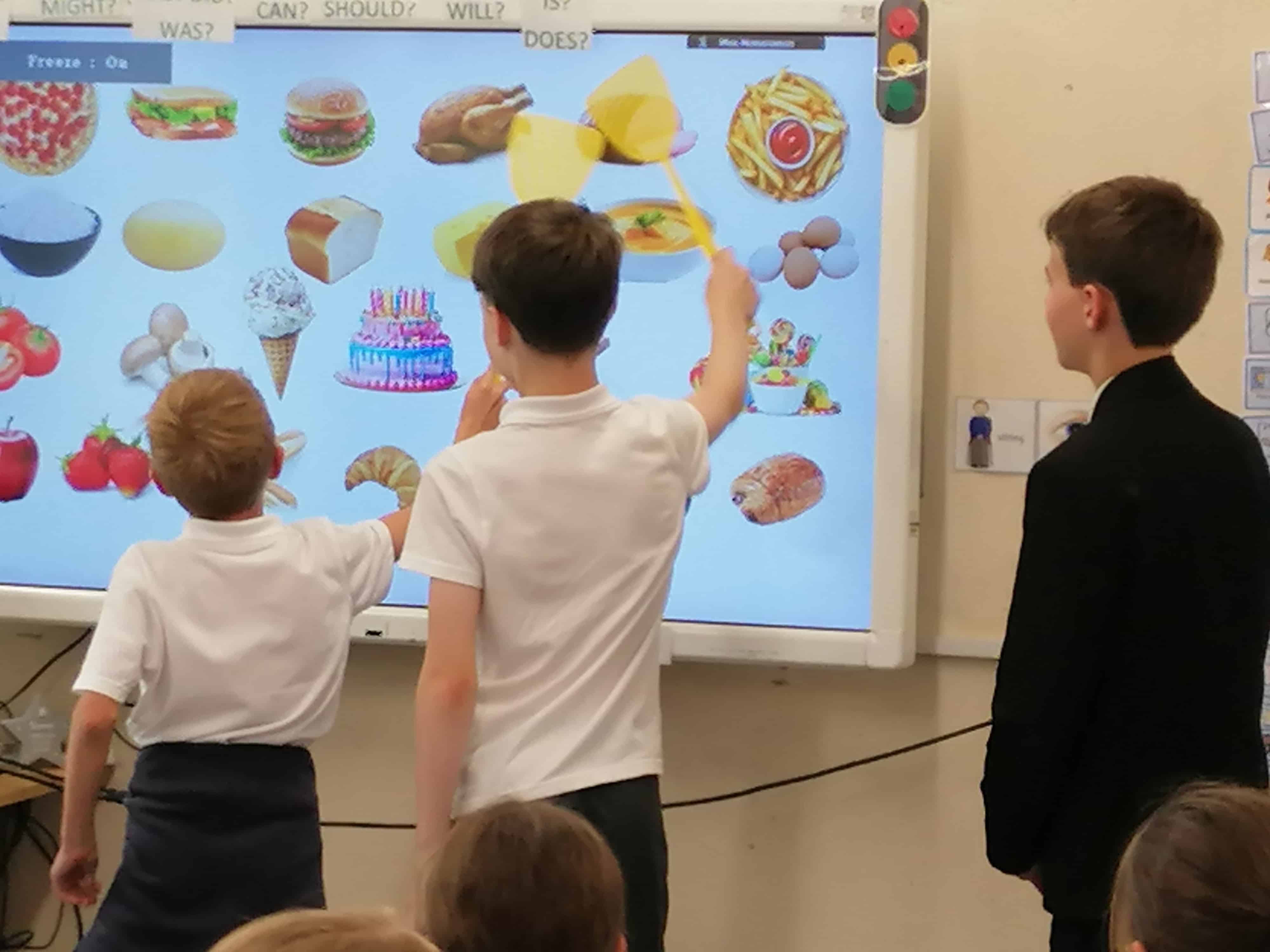 Languages Ambassadors from Priestnall School support primary school pupils during a language lesson.