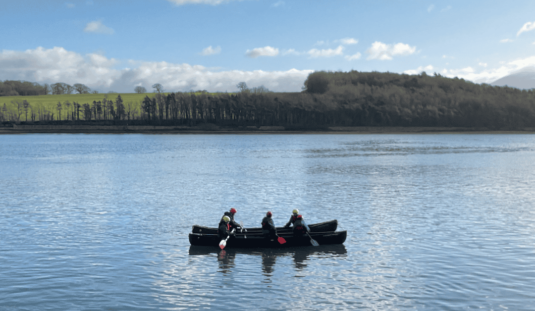 Students from Priestnall School navigate a canoe on Menai Strait during their visit to the Conway Centre in Anglesey.
