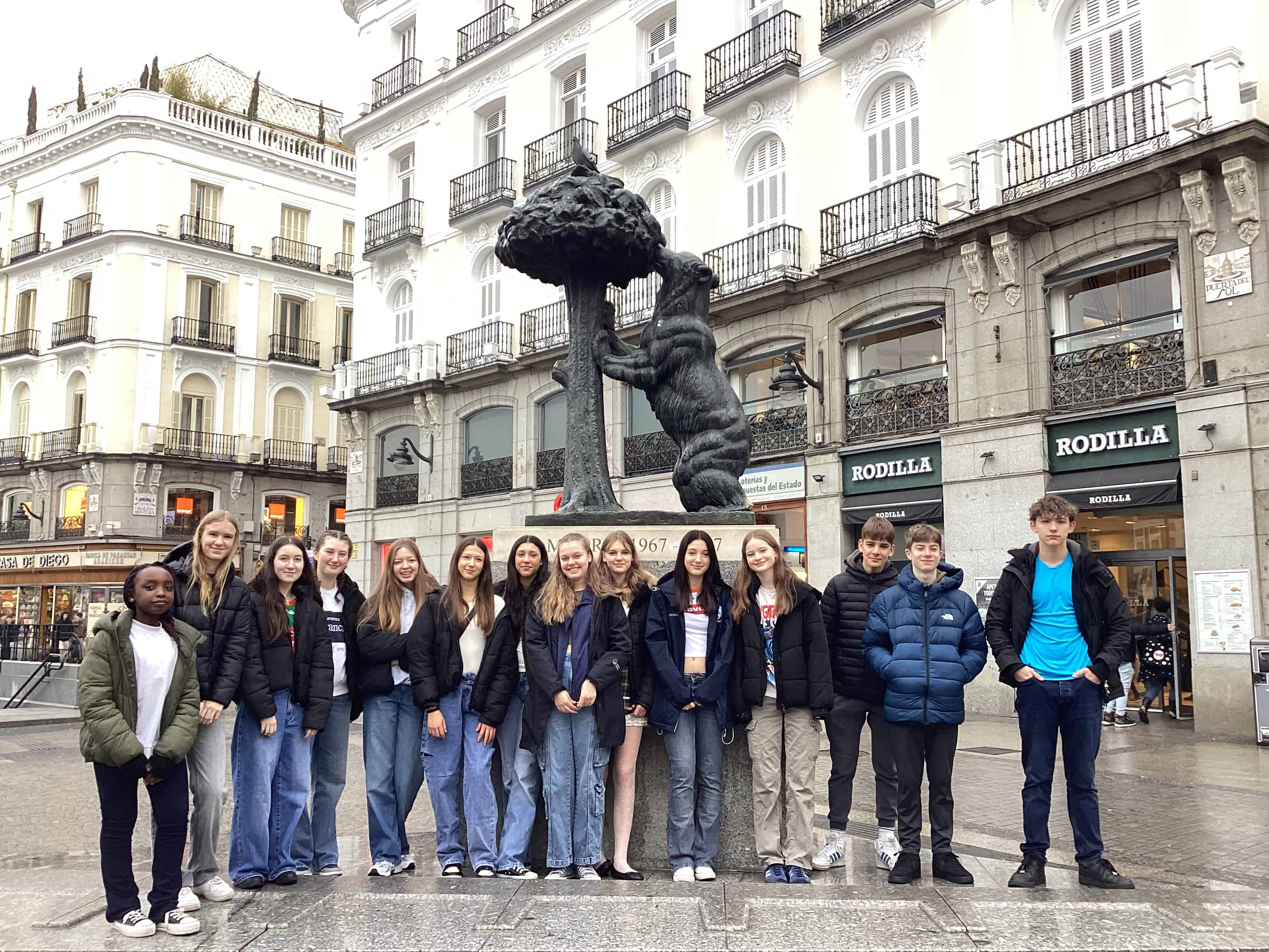 Students from Priestnall School stand in front of a sculpture at Puerta Del Sol.