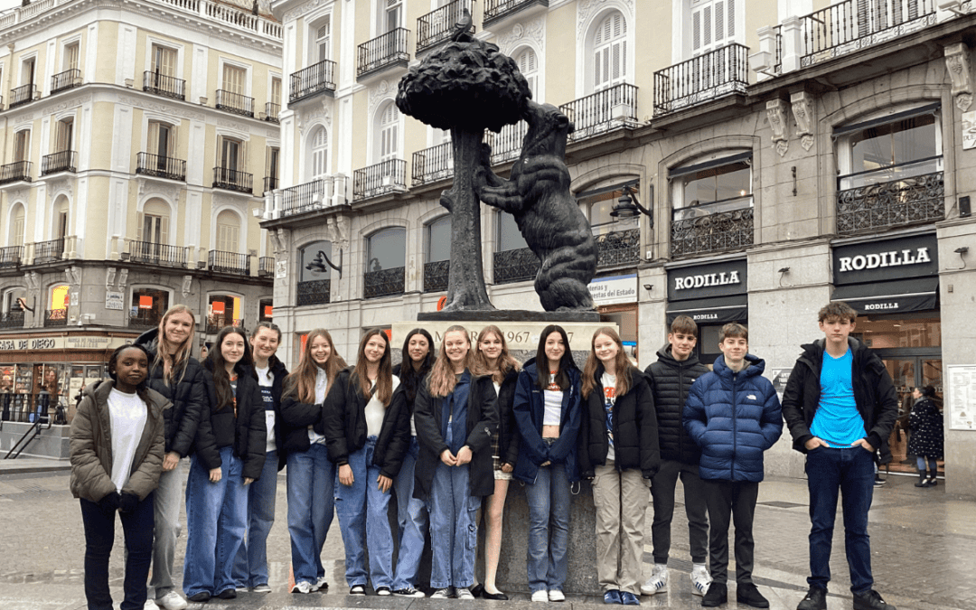Students from Priestnall School stand in front of a sculpture at Puerta Del Sol.
