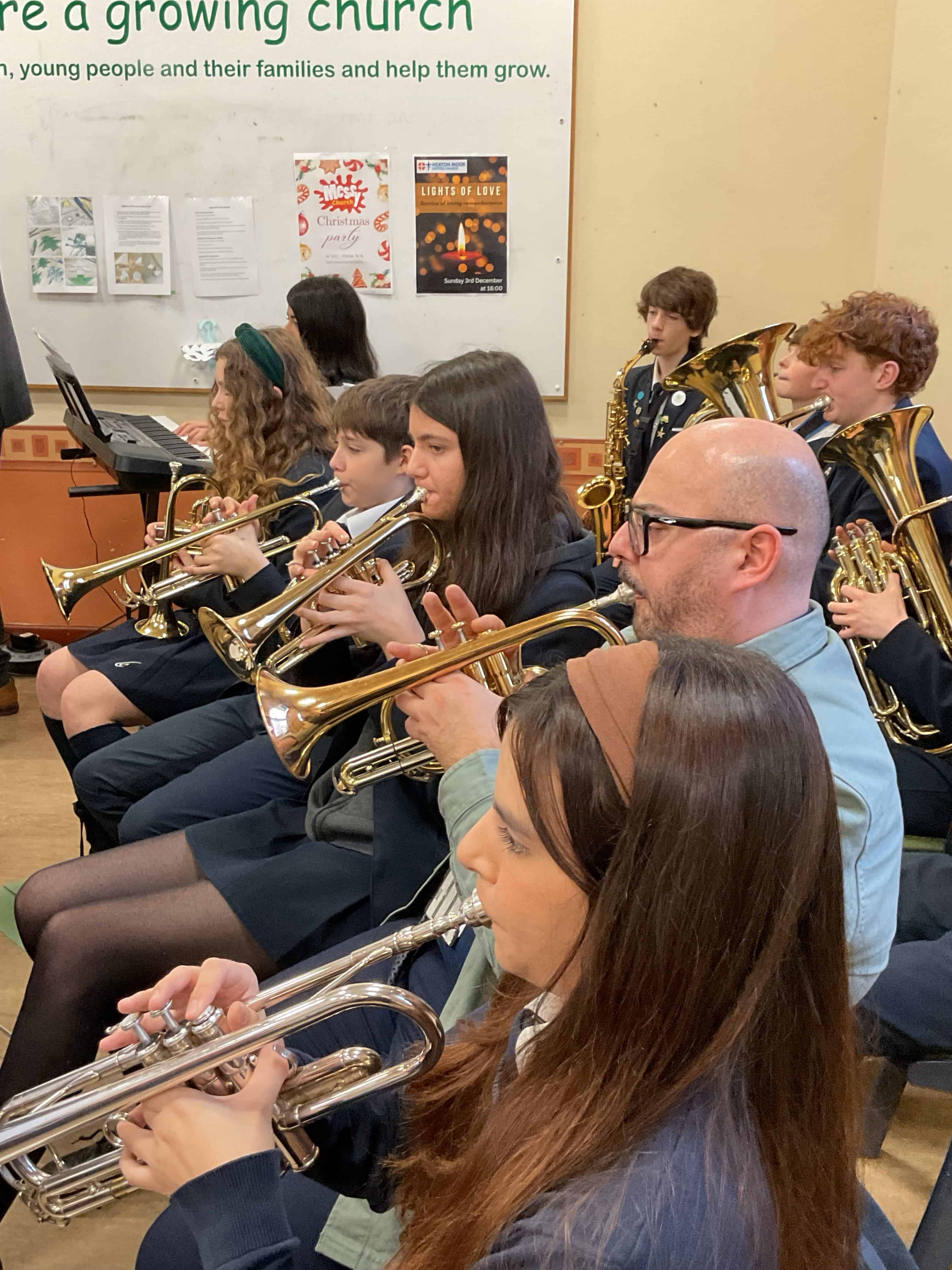 Students and staff from Priestnall School perform at the Dementia Friendly Heatons' Christmas party.